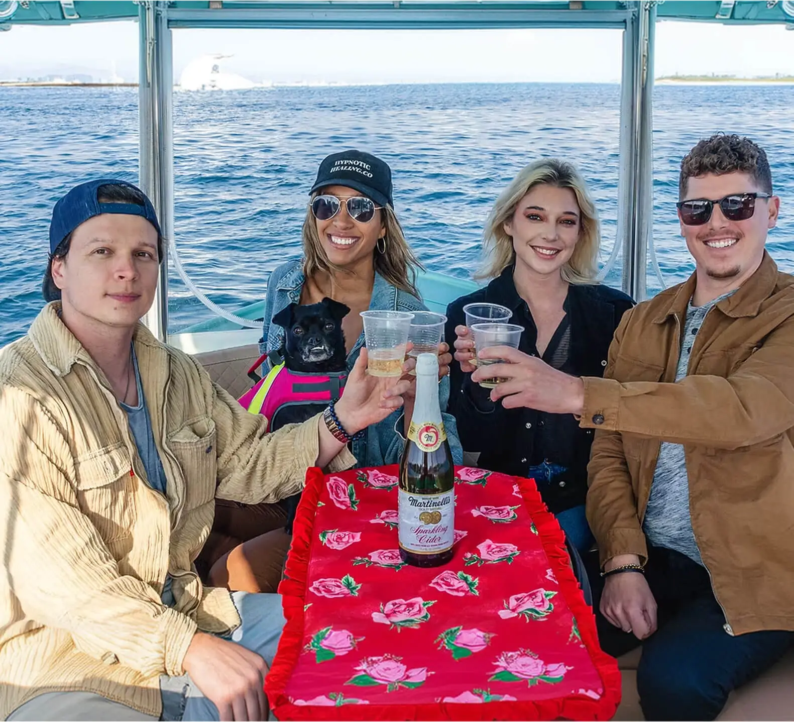 Friends toasting drinks on a sunset cruise